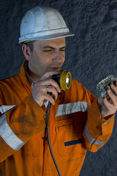 a mining engineer inspecting a mine rock